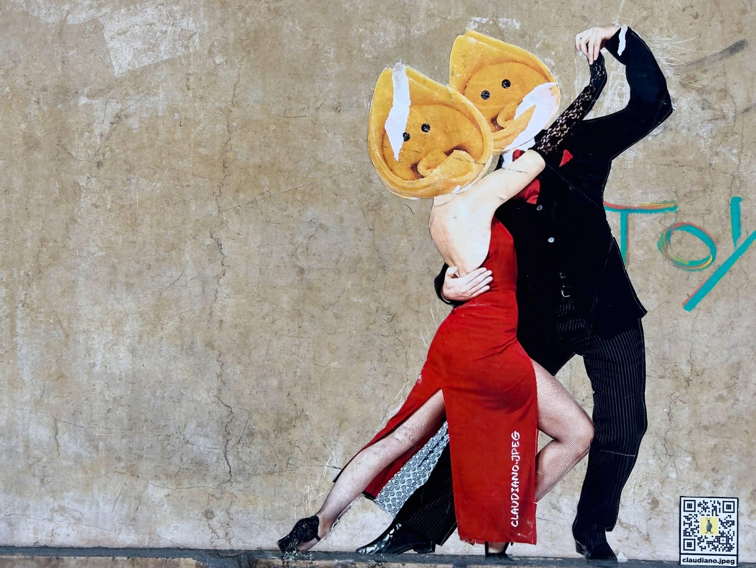 A street art mural shows two dancers in elegant tango poses, wearing formal attire. Both have fortune cookie halves as heads and are dancing against a textured beige wall with graffiti and a small QR code in the corner.