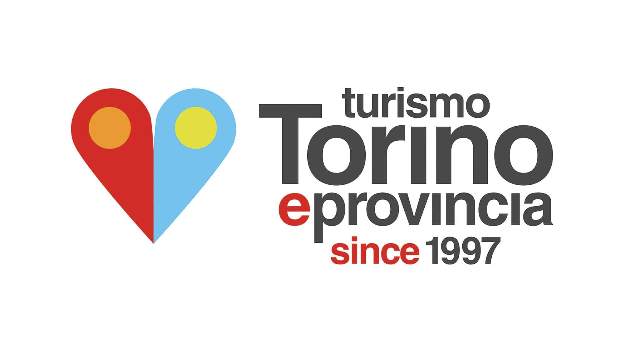 Logo featuring a red and blue heart-shaped map pin with yellow circles, alongside the text "turismo Torino e provincia since 1997" in black and red on a white background.