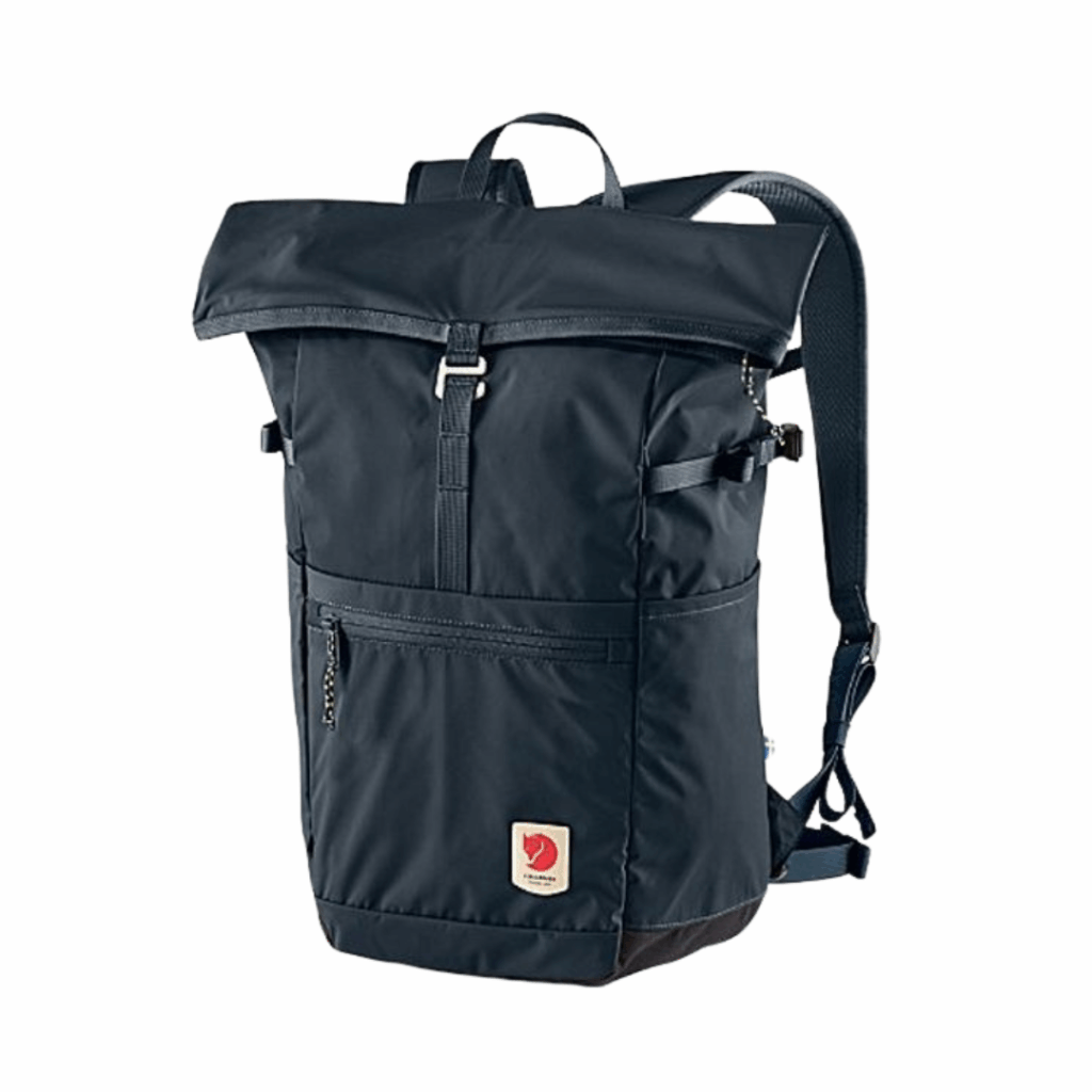 A dark blue roll-top backpack with adjustable shoulder straps, a front zipper pocket, and an orange fox logo patch on the lower front. The main compartment has a fold-over top secured by a buckle.