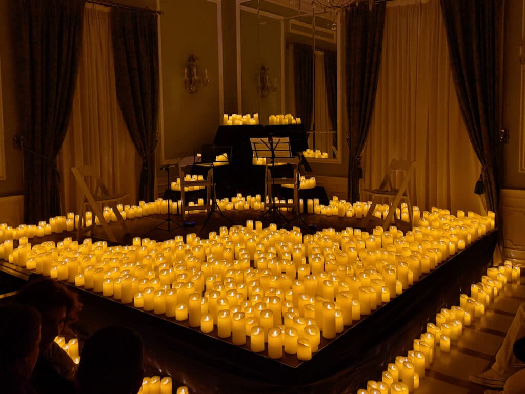 A large group of candles on a table evokes the warm, festive ambiance of Granada in December.