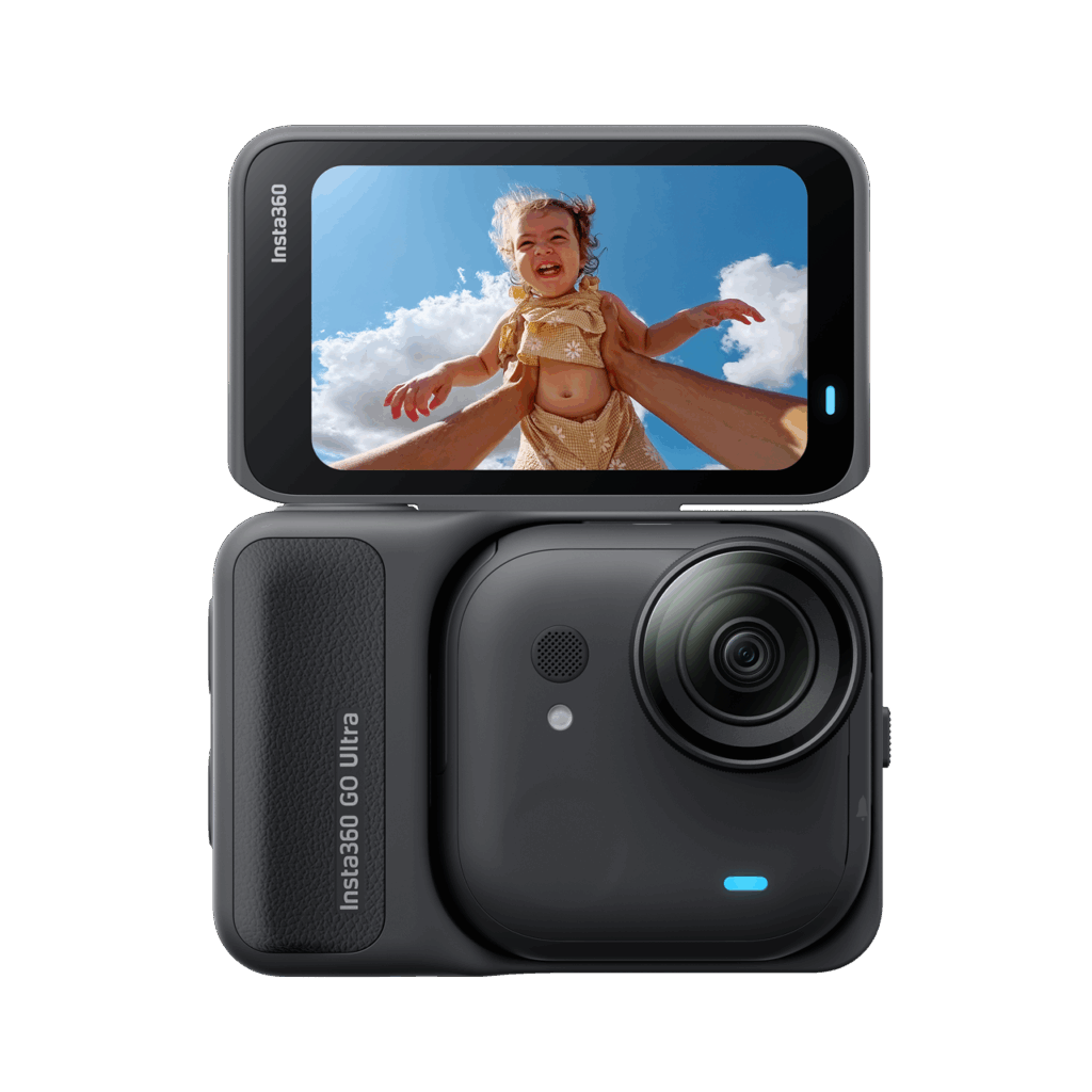 A compact Insta360 GO Ultra camera with its screen flipped open, displaying a photo of a joyful child in a yellow dress being lifted into the air against a blue sky with clouds.
